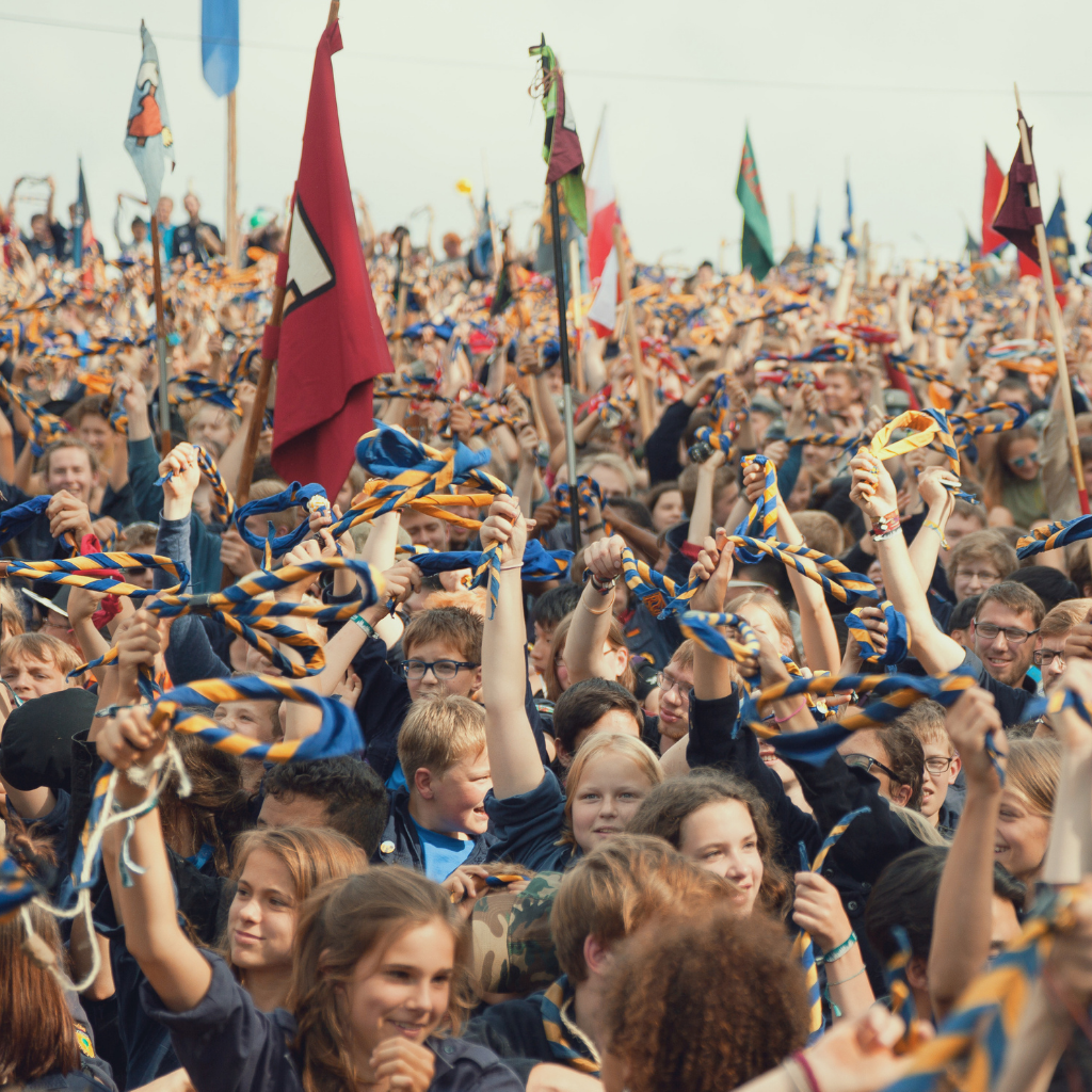 A crowd of scouts waving their scarves